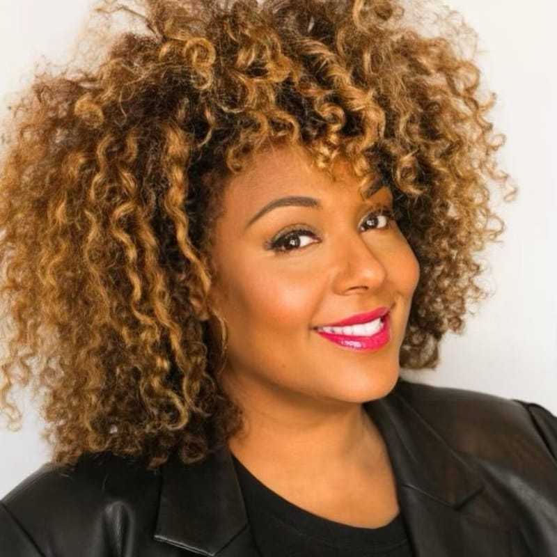 Portrait of Michaella, a professional stylist at [salon] 718, showcasing their expertise and style.