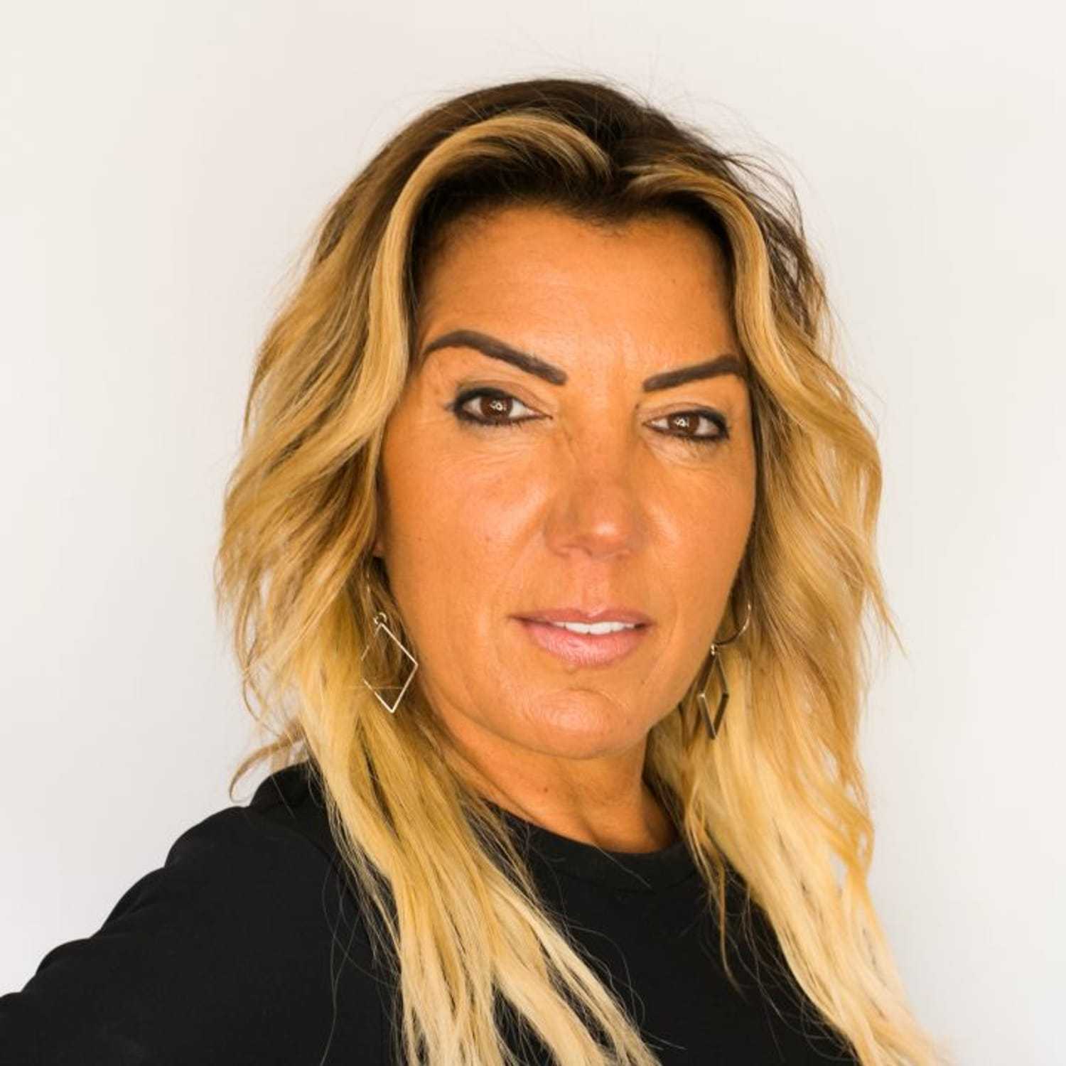 Portrait of Olympia, a professional stylist at [salon] 718, showcasing their expertise and style.