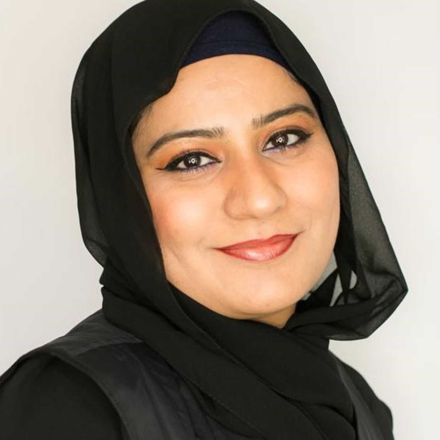 Portrait of Uzma, a professional stylist at [salon] 718, showcasing their expertise and style.