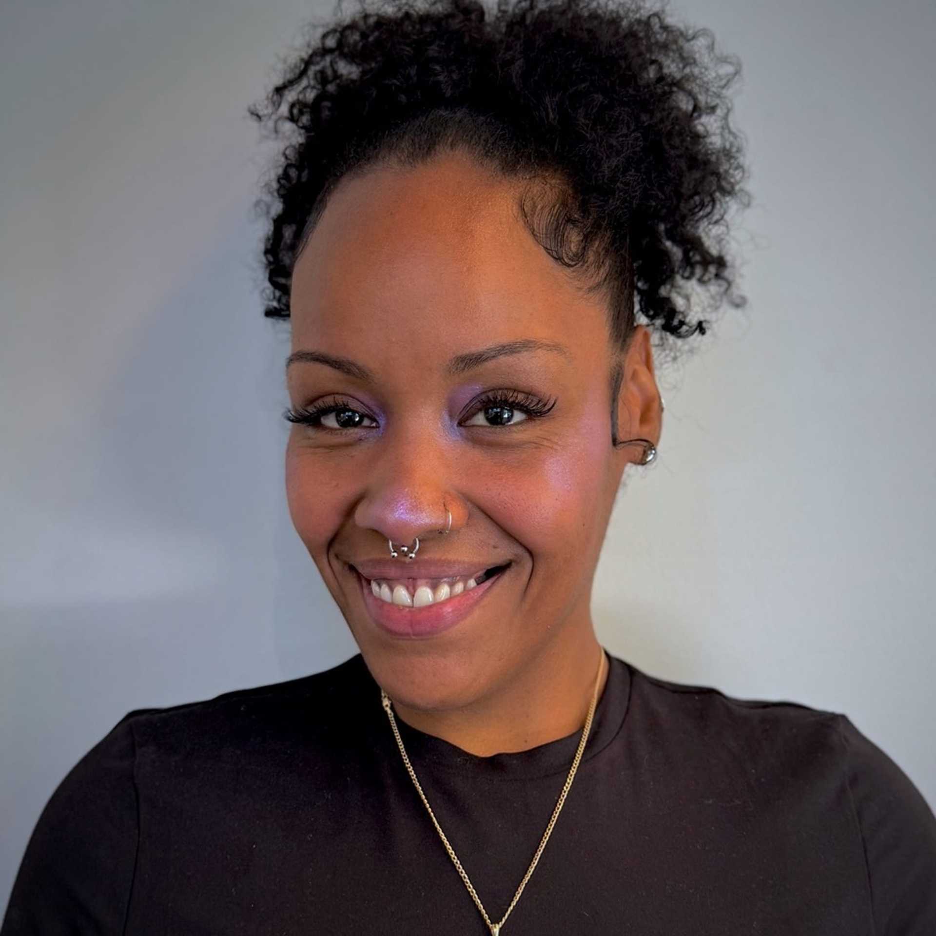 Portrait of Krystal, a professional stylist at [salon] 718, showcasing their expertise and style.