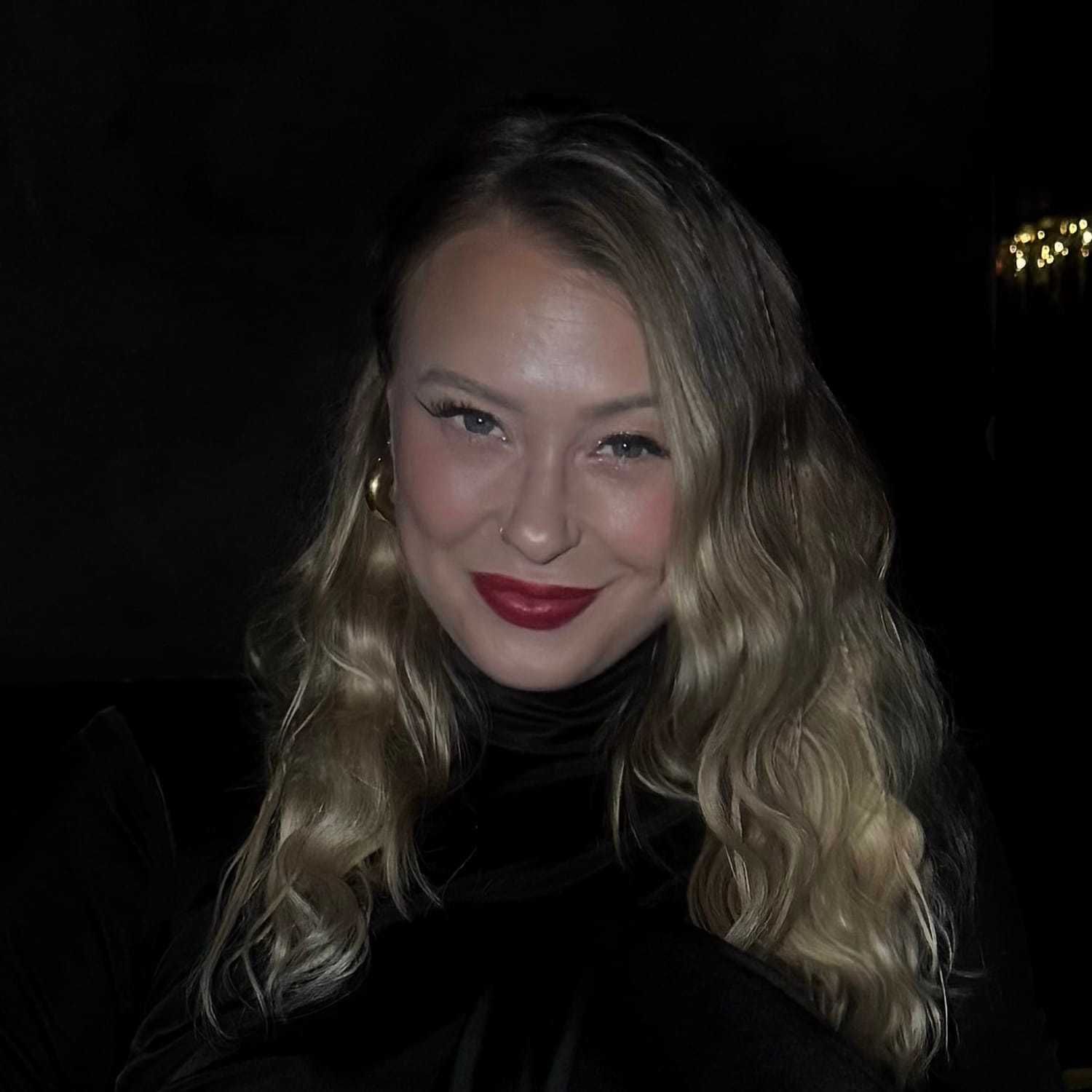 Portrait of Lauren, a professional stylist at [salon] 718, showcasing their expertise and style.