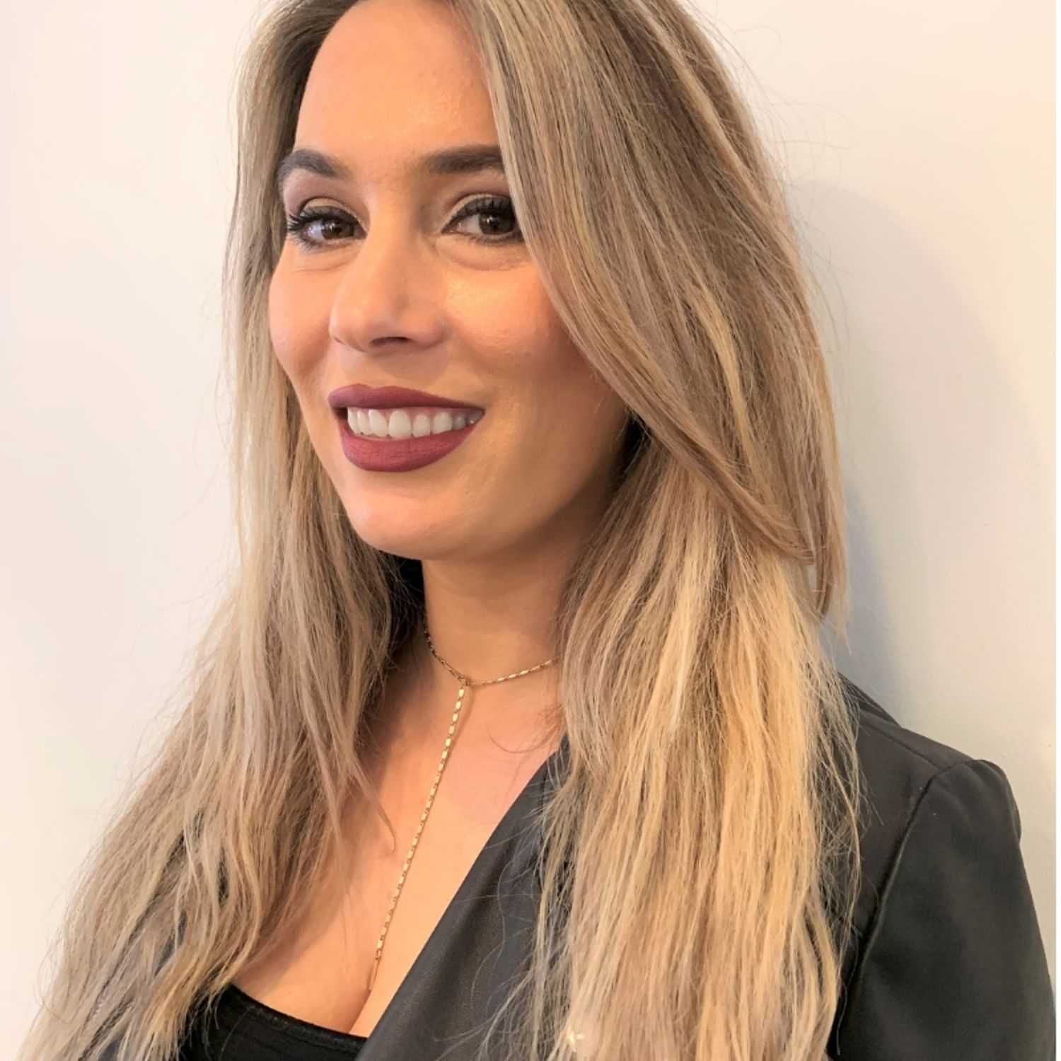 Portrait of Aida, a professional stylist at [salon] 718, showcasing their expertise and style.