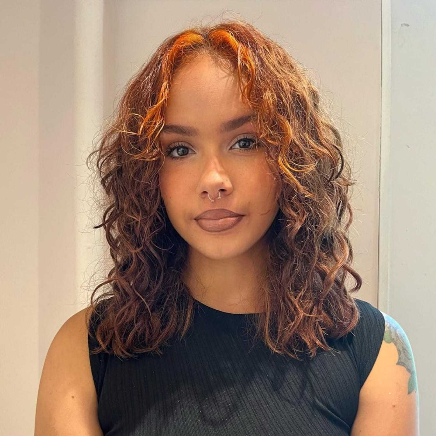 Portrait of Iyanna, a professional stylist at [salon] 718, showcasing their expertise and style.