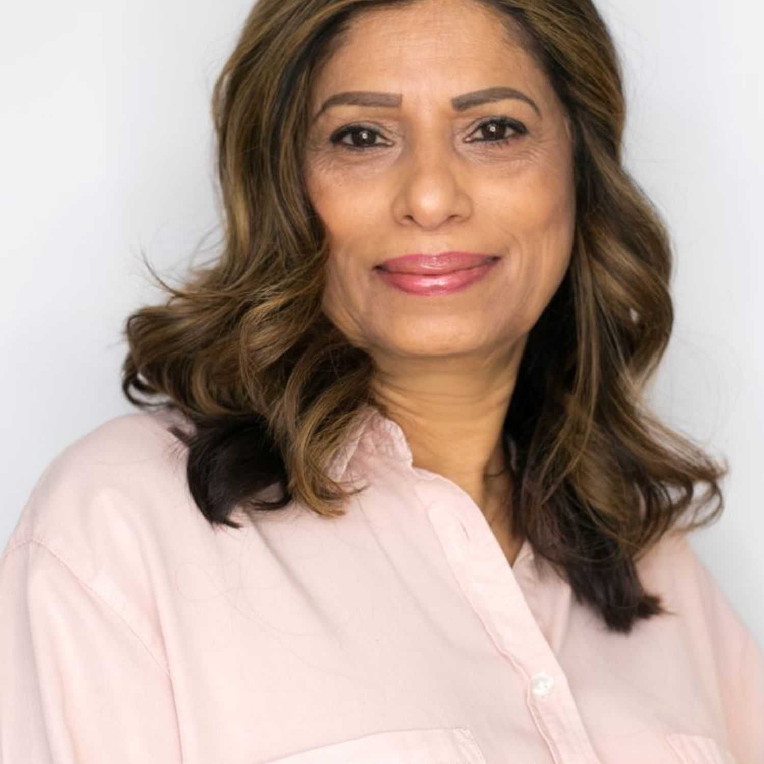 Portrait of Tasneem, a professional stylist at [salon] 718, showcasing their expertise and style.