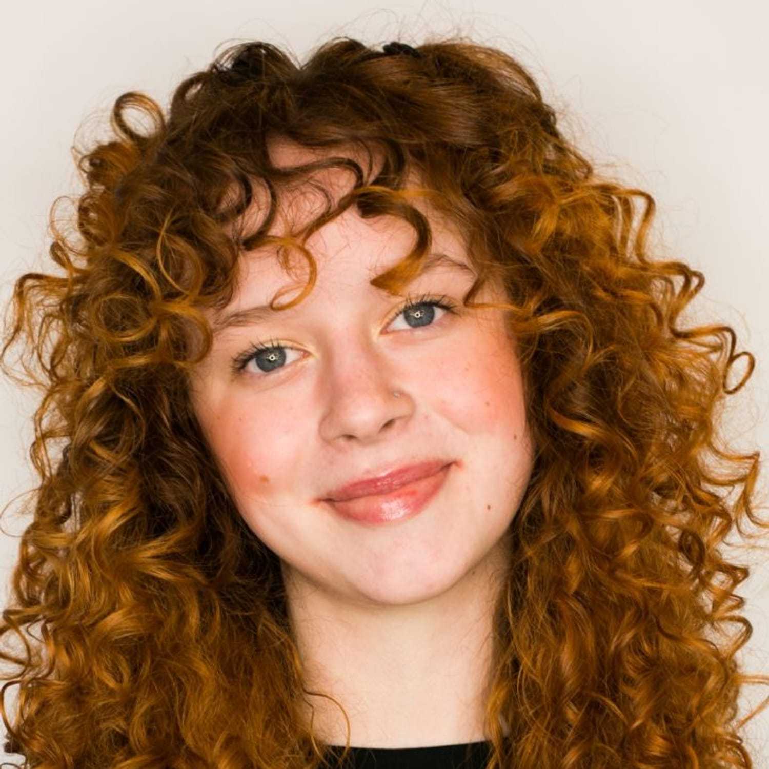 Portrait of Nicole, a professional stylist at [salon] 718, showcasing their expertise and style.