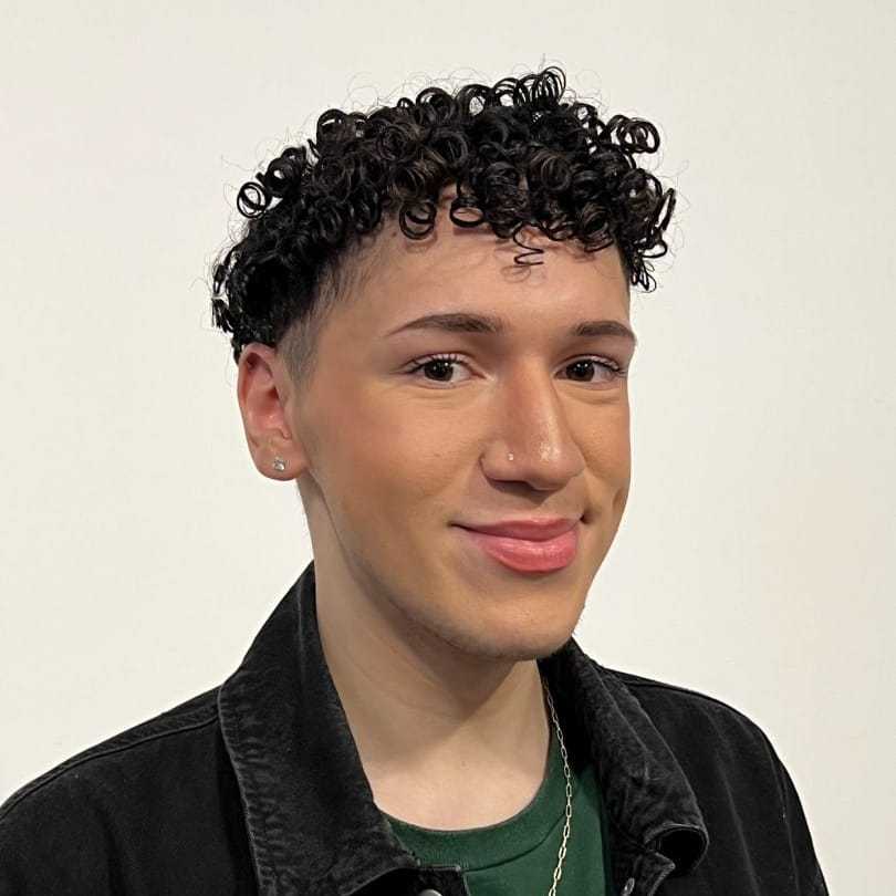 Portrait of Brandon, a professional stylist at [salon] 718, showcasing their expertise and style.