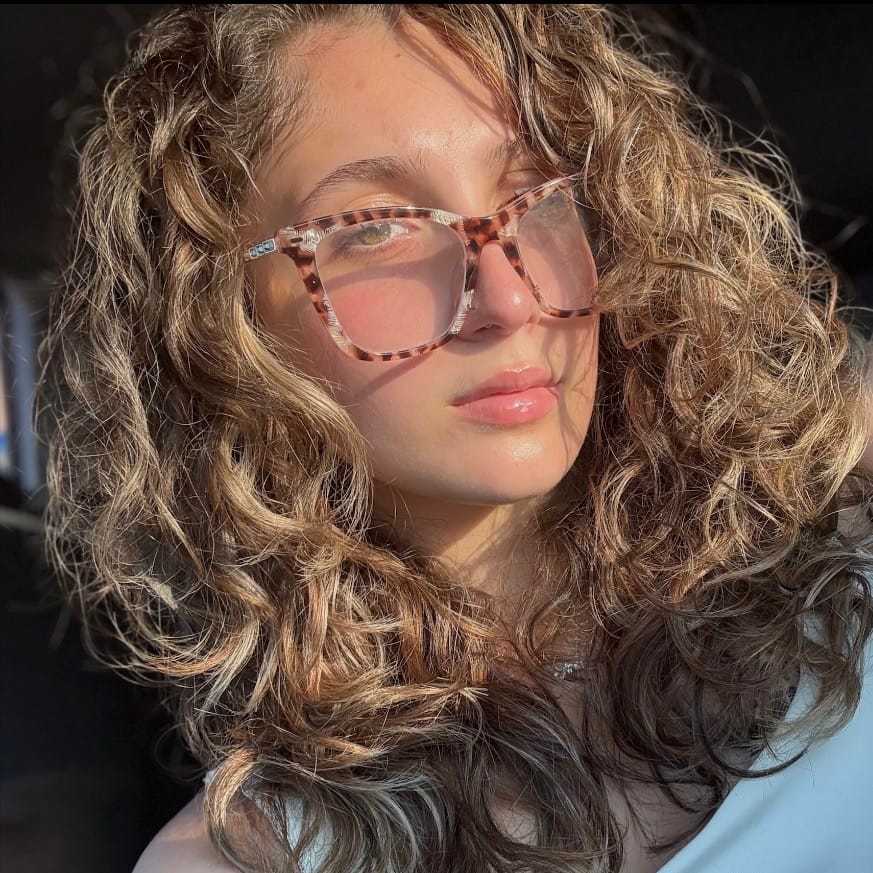 Portrait of Jacqueline, a professional stylist at [salon] 718, showcasing their expertise and style.