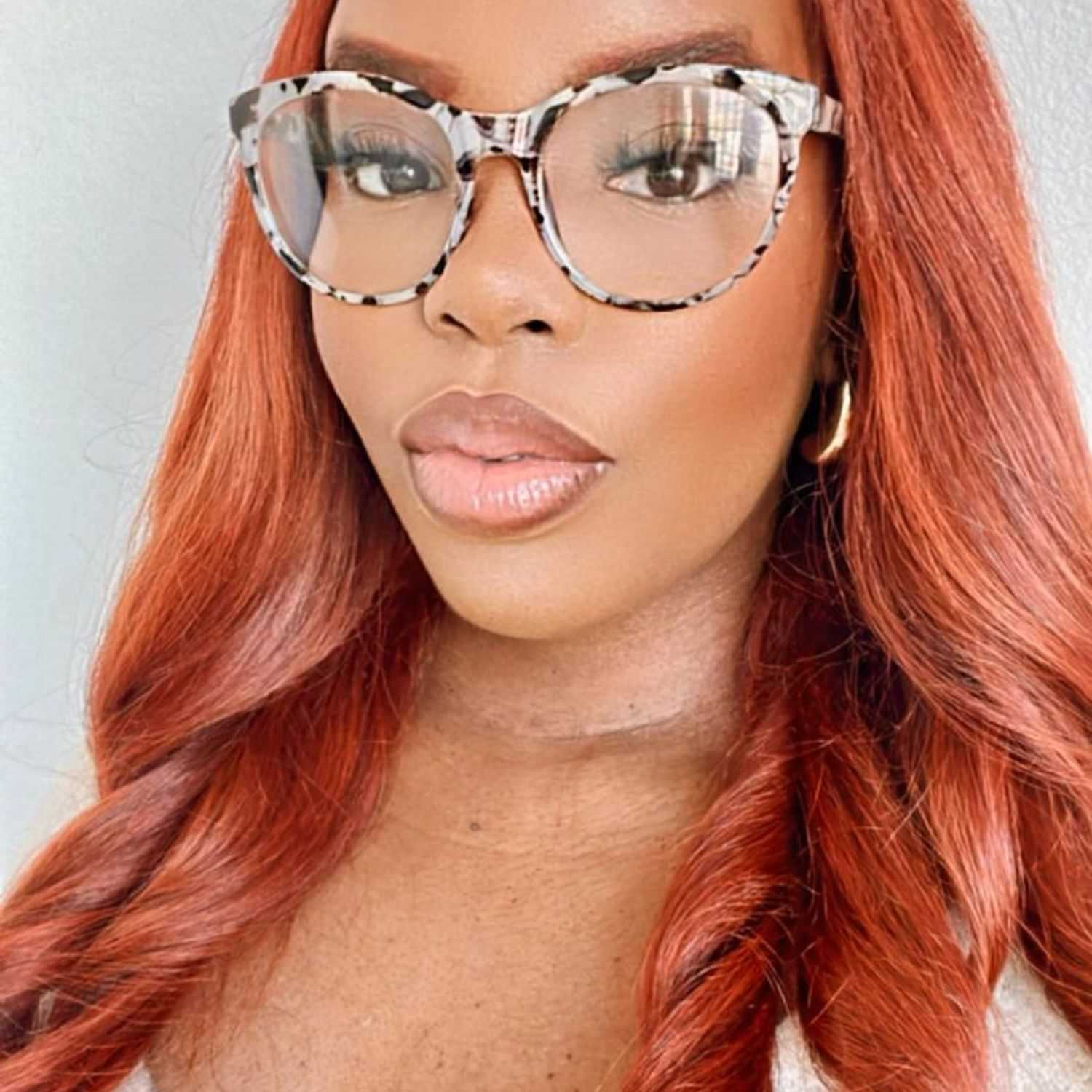 Portrait of Kenya, a professional stylist at [salon] 718, showcasing their expertise and style.