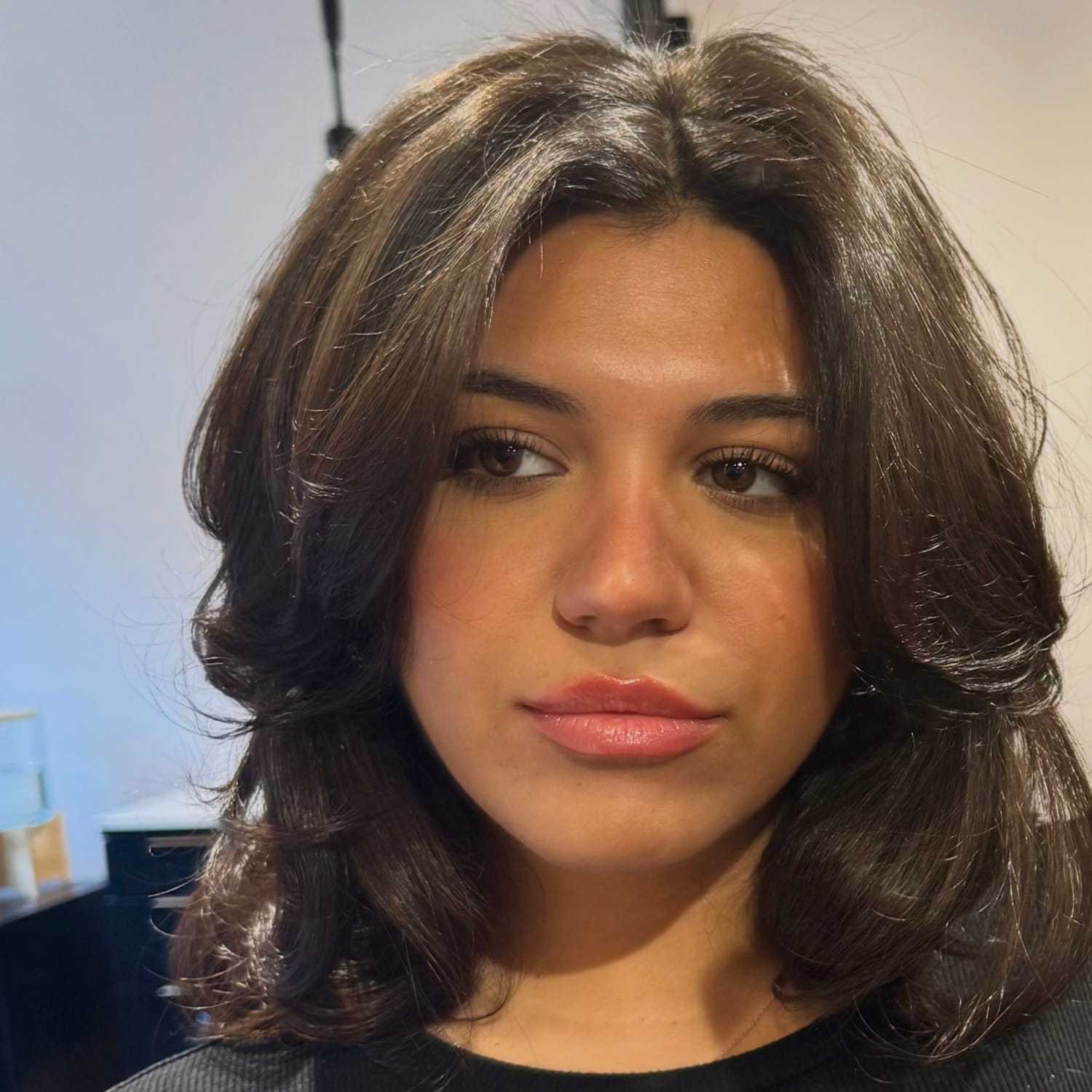 Portrait of Angela, a professional stylist at [salon] 718, showcasing their expertise and style.