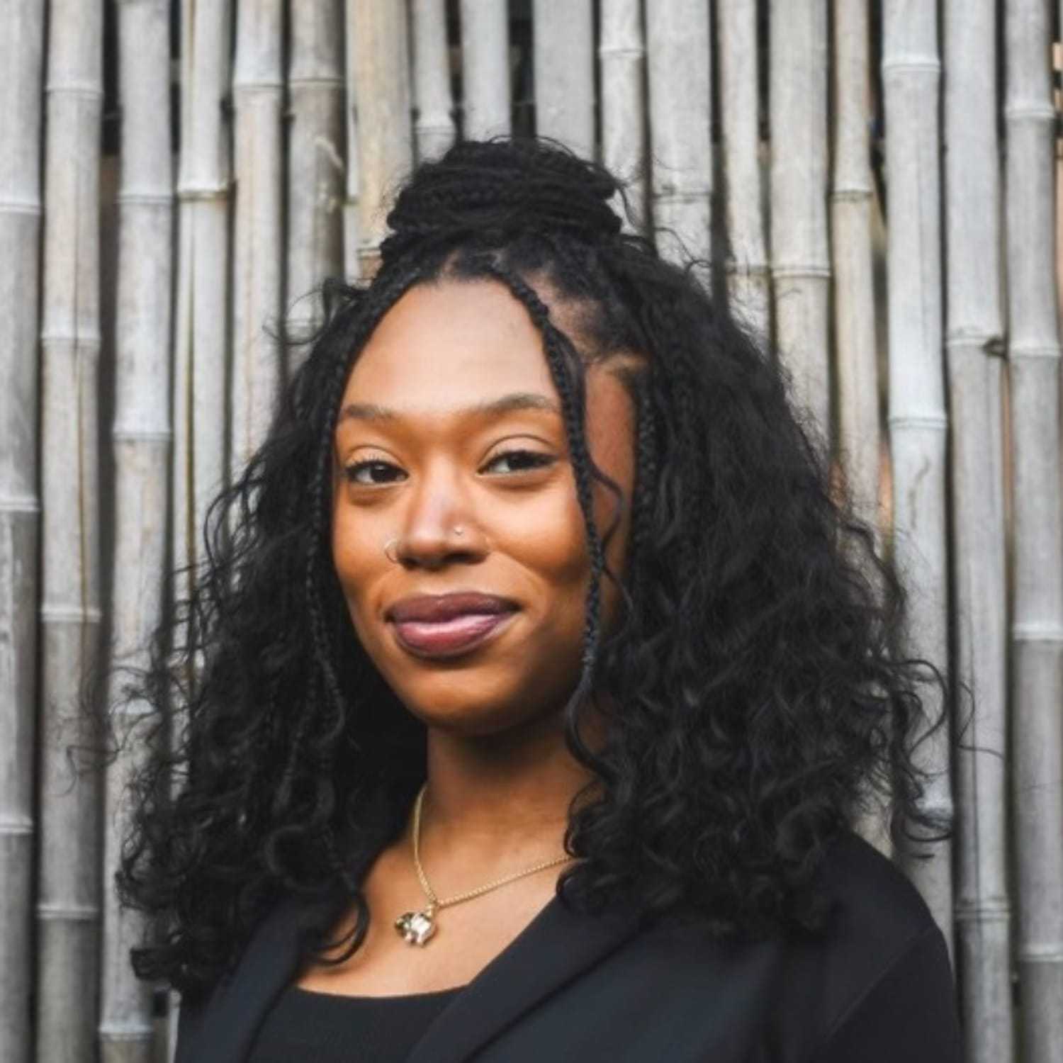 Portrait of Adriana, a professional stylist at [salon] 718, showcasing their expertise and style.