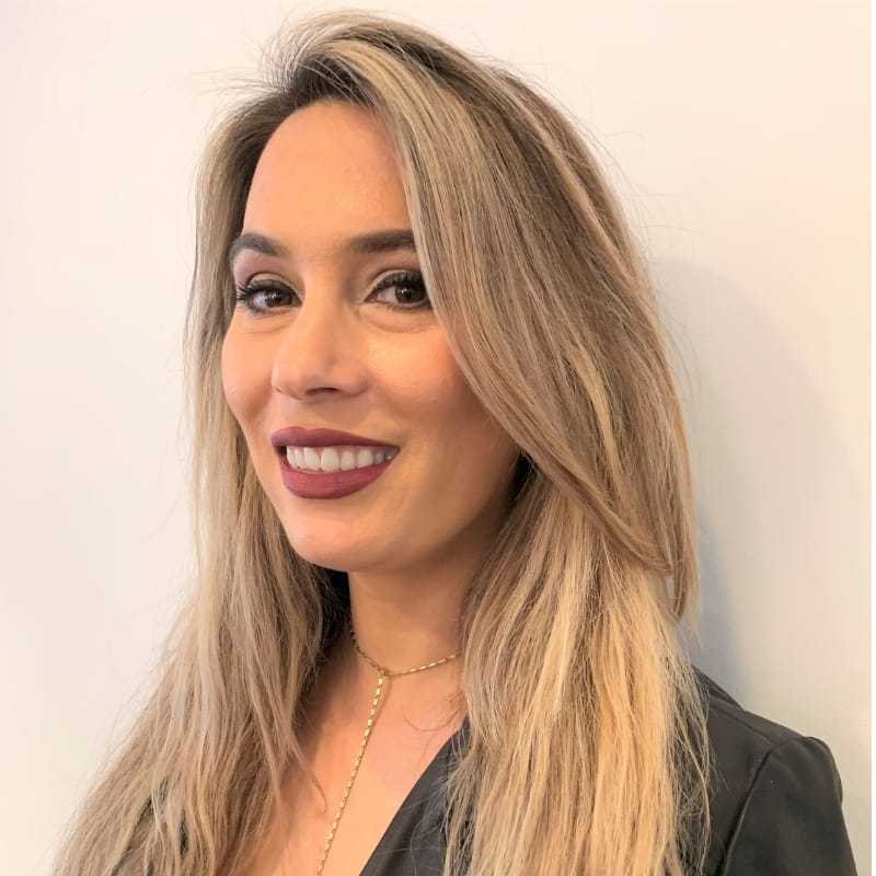 Portrait of Aida, a professional stylist at [salon] 718, showcasing their expertise and style.