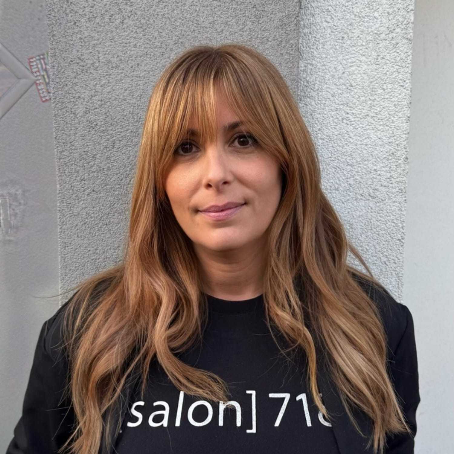 Portrait of Donna, a professional stylist at [salon] 718, showcasing their expertise and style.