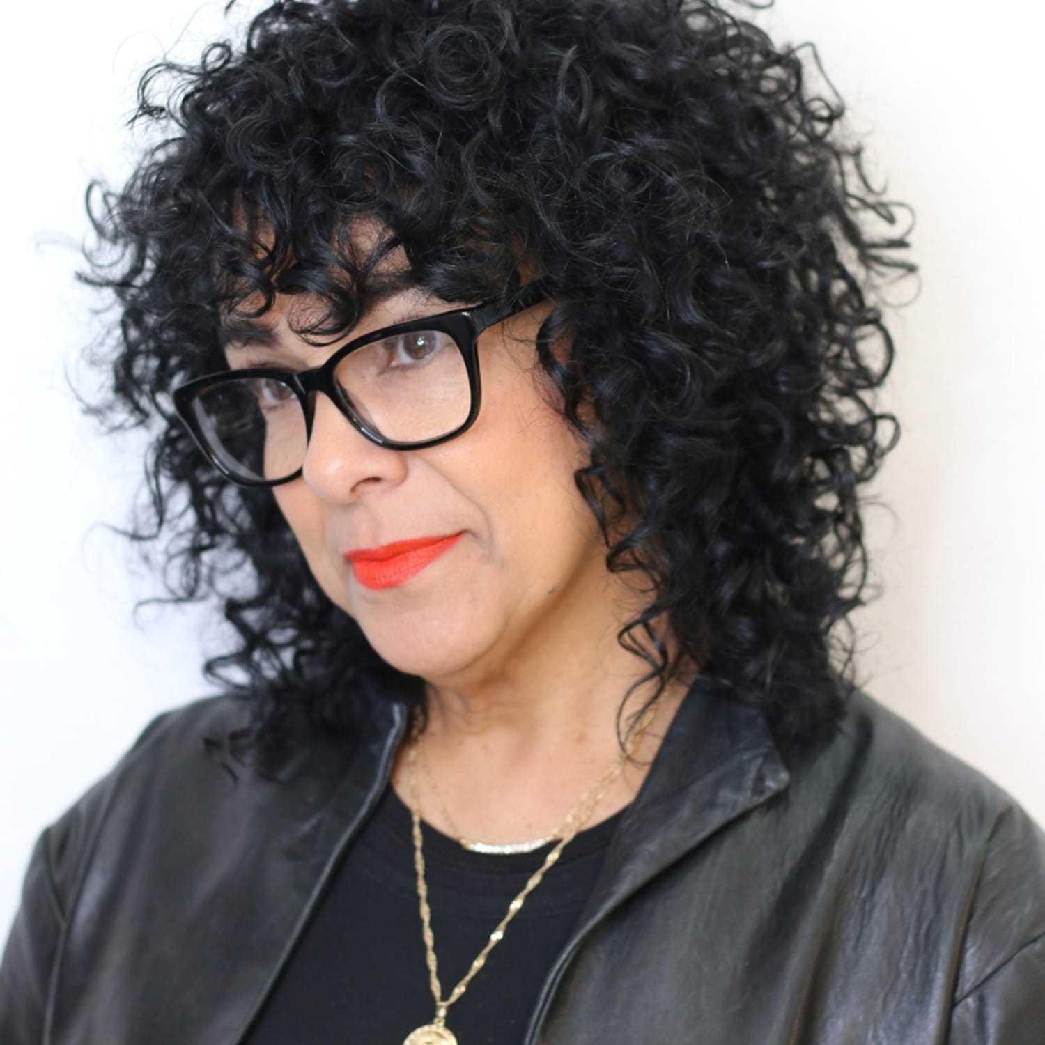 Portrait of Cynthia, a professional stylist at [salon] 718, showcasing their expertise and style.