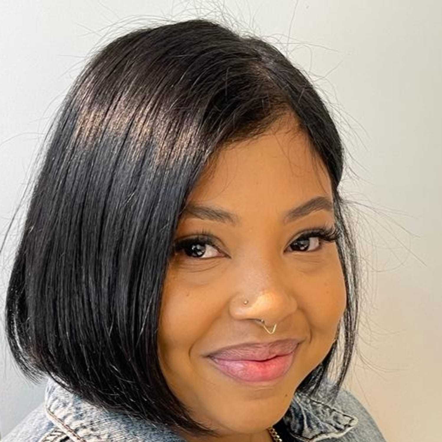 Portrait of Marlene, a professional stylist at [salon] 718, showcasing their expertise and style.