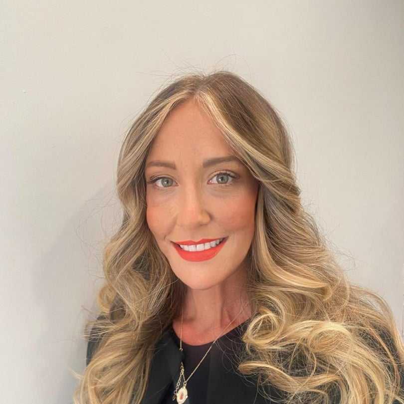 Portrait of Corinne, a professional stylist at [salon] 718, showcasing their expertise and style.