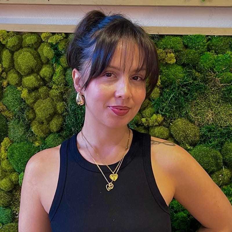 Portrait of Martha, a professional stylist at [salon] 718, showcasing their expertise and style.