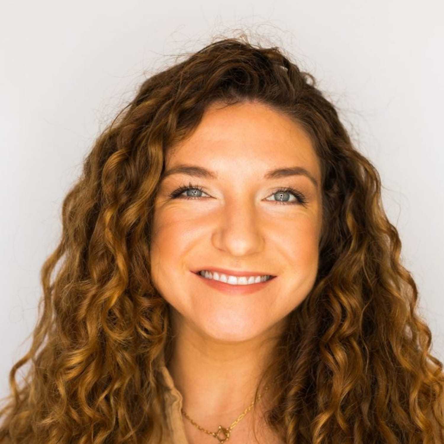 Portrait of Sarah, a professional stylist at [salon] 718, showcasing their expertise and style.