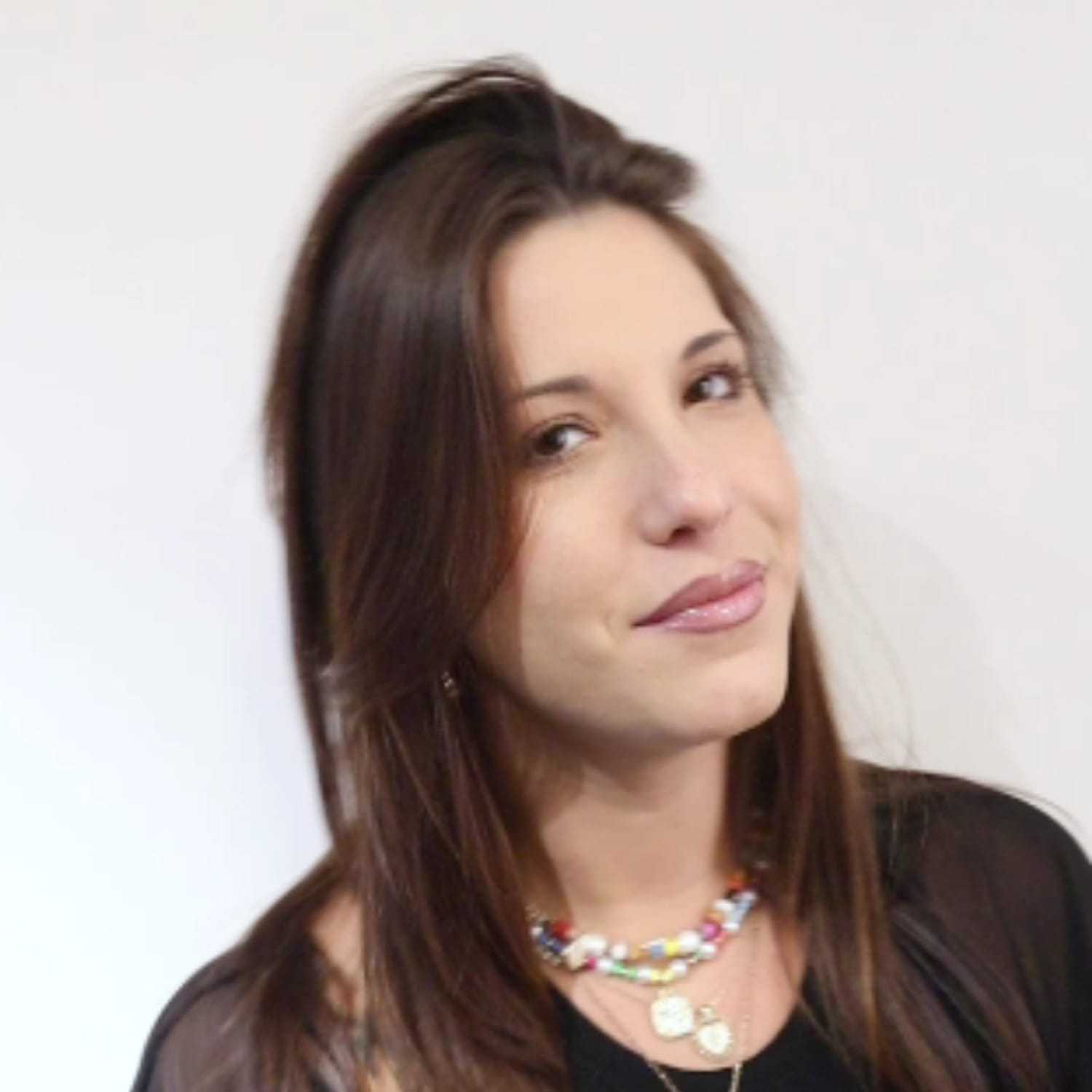 Portrait of Jenny G, a professional stylist at [salon] 718, showcasing their expertise and style.