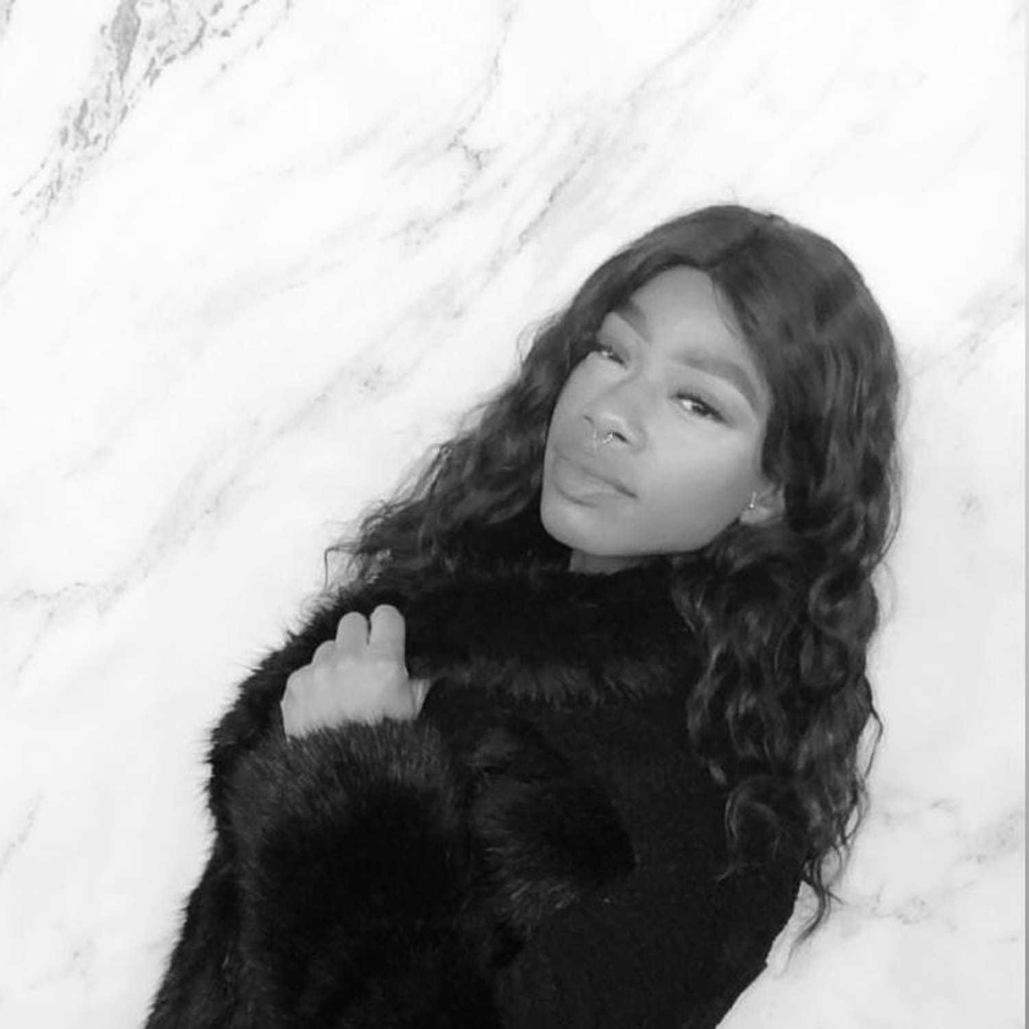 Portrait of Diamond, a professional stylist at [salon] 718, showcasing their expertise and style.