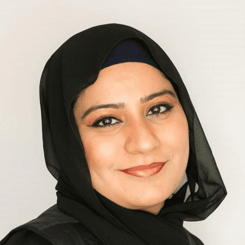 Portrait of Uzma, a professional stylist at [salon] 718, showcasing their expertise and style.