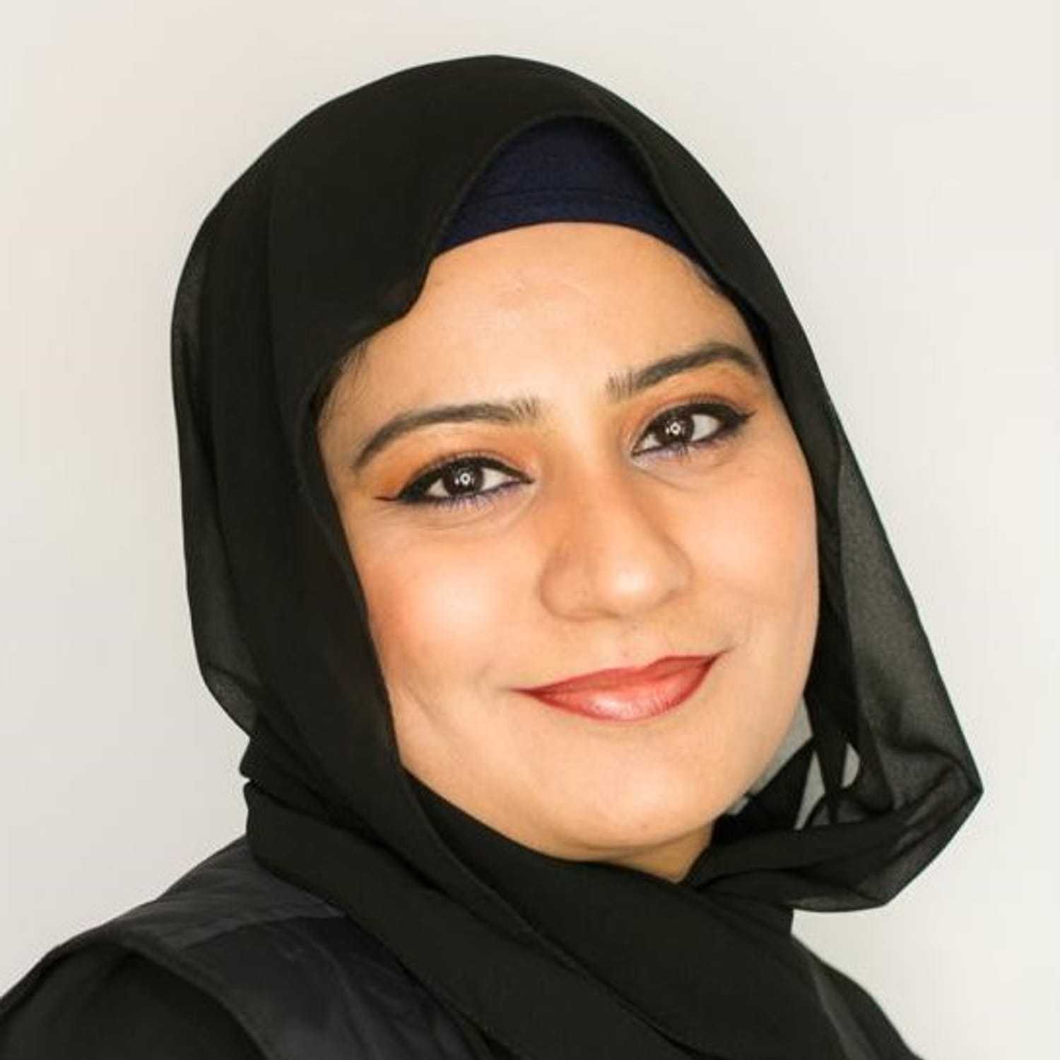 Portrait of Uzma, a professional stylist at [salon] 718, showcasing their expertise and style.