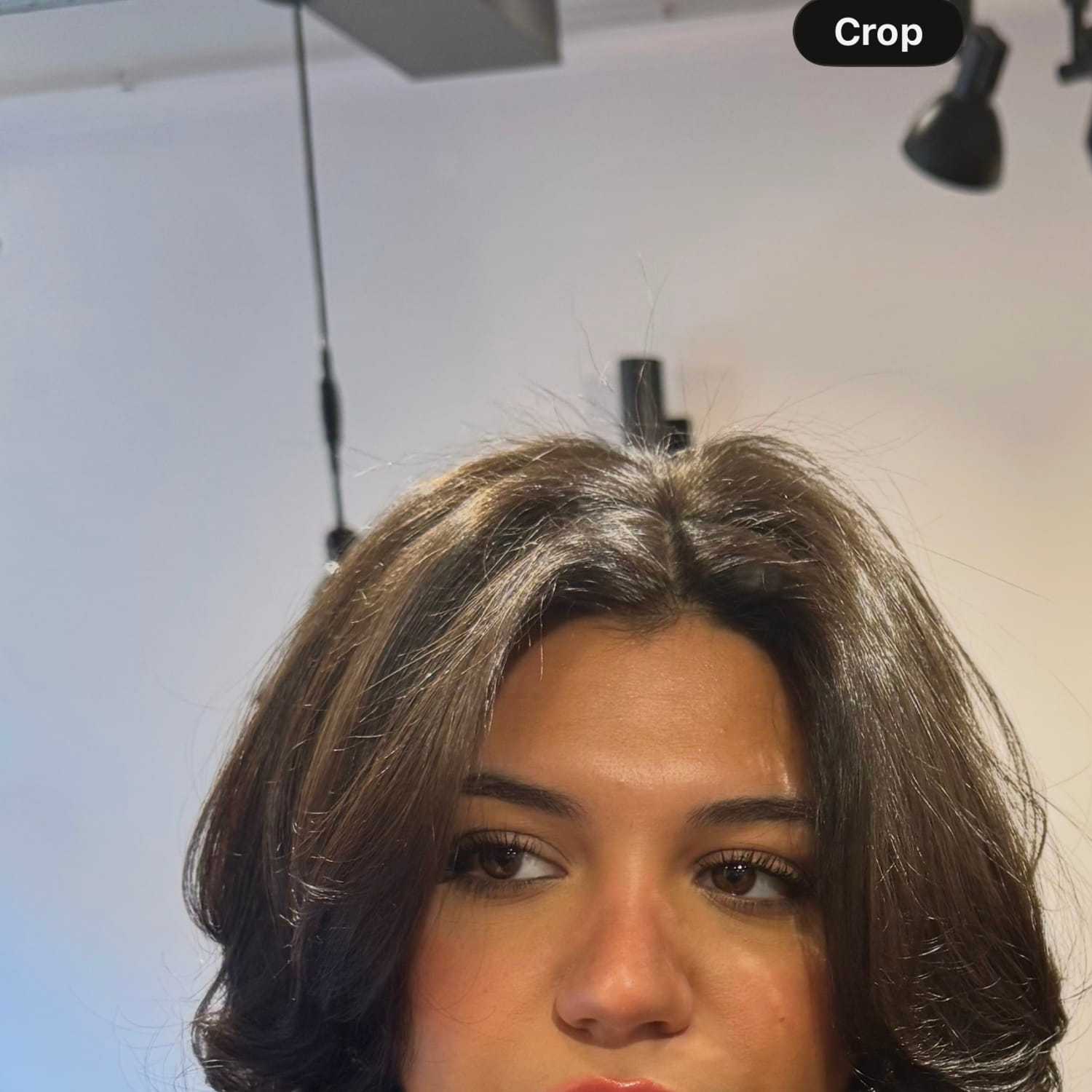 Portrait of Angela, a professional stylist at [salon] 718, showcasing their expertise and style.