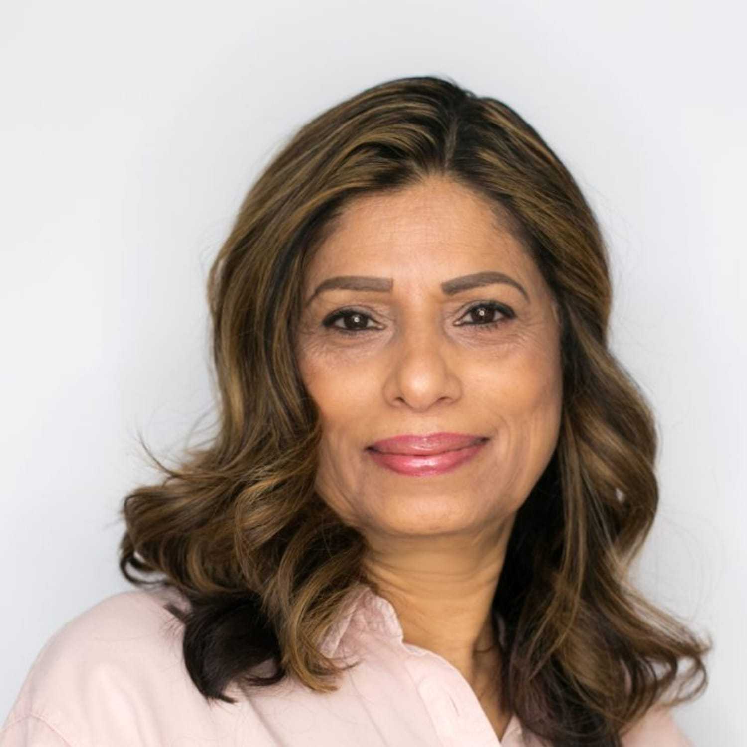 Portrait of Tasneem, a professional stylist at [salon] 718, showcasing their expertise and style.