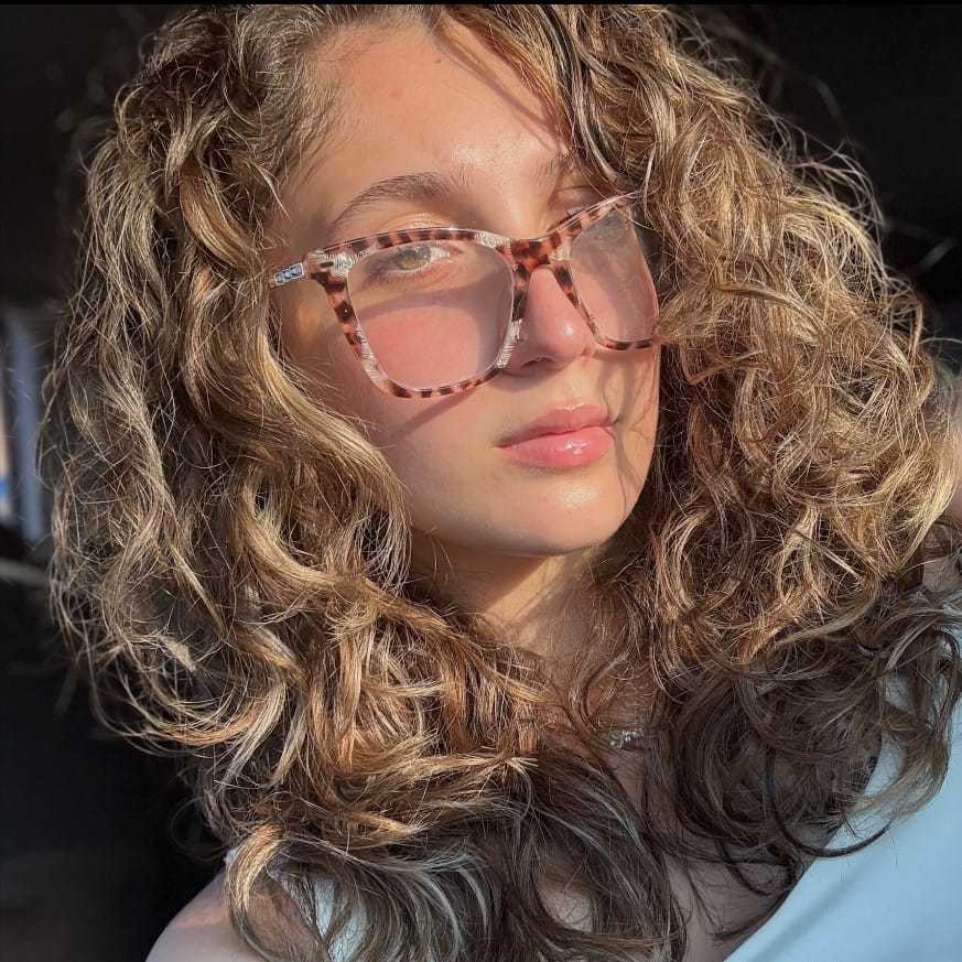 Portrait of Jacqueline, a professional stylist at [salon] 718, showcasing their expertise and style.