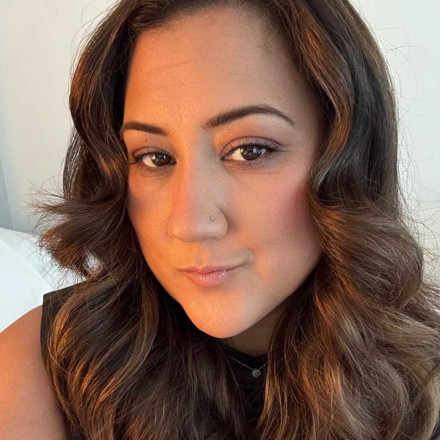 Portrait of Felicia, a professional stylist at [salon] 718, showcasing their expertise and style.