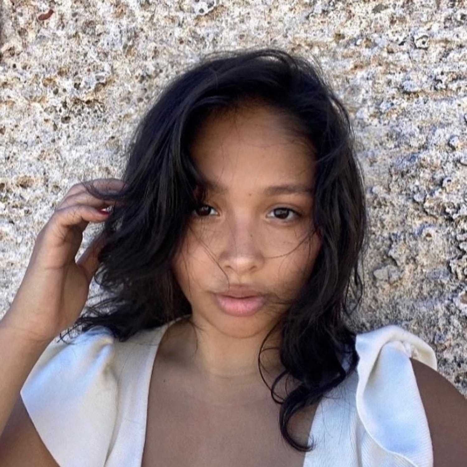 Portrait of Nalani, a professional stylist at [salon] 718, showcasing their expertise and style.