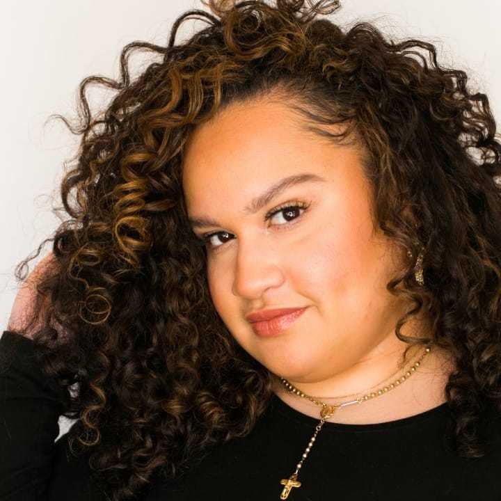 Portrait of Ello, a professional stylist at [salon] 718, showcasing their expertise and style.