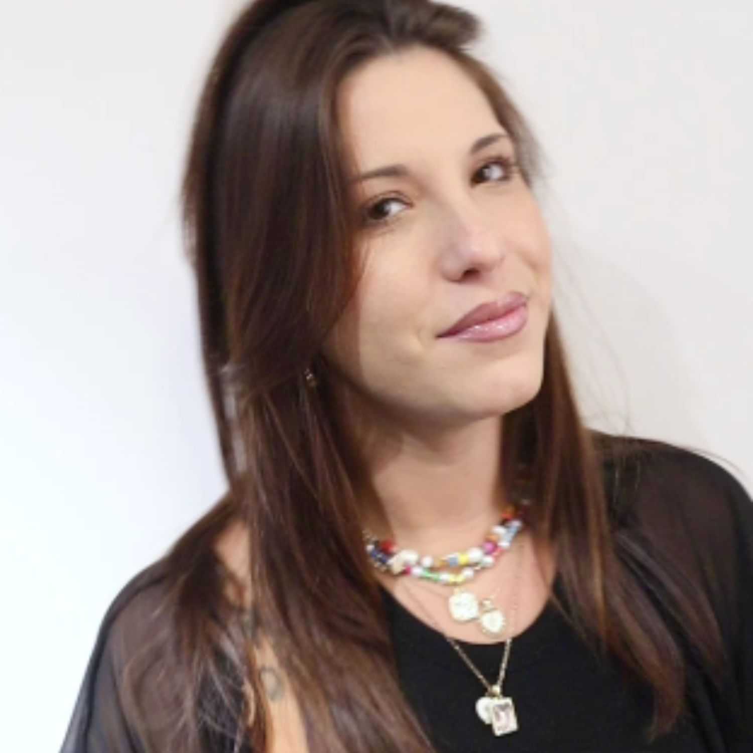 Portrait of Jenny G, a professional stylist at [salon] 718, showcasing their expertise and style.