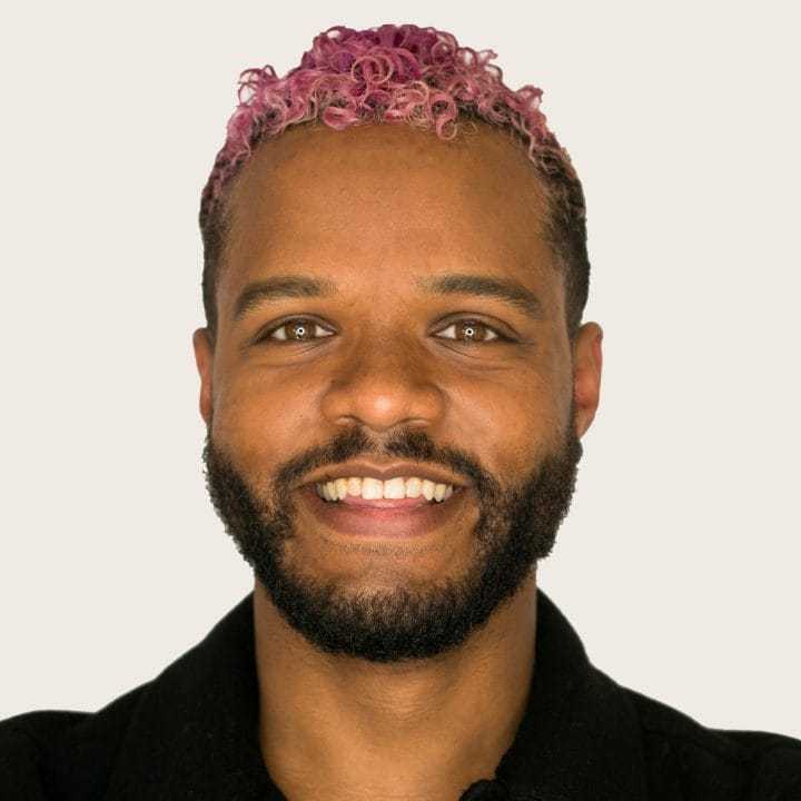 Portrait of Juan, a professional stylist at [salon] 718, showcasing their expertise and style.