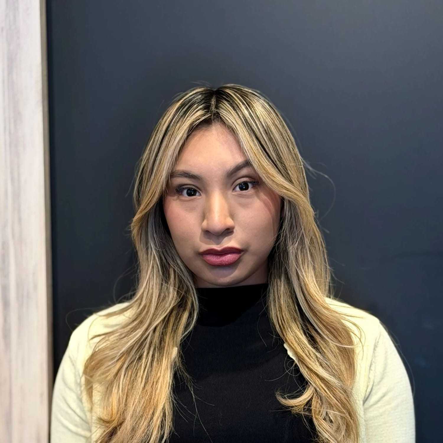 Portrait of Jennifer P., a professional stylist at [salon] 718, showcasing their expertise and style.