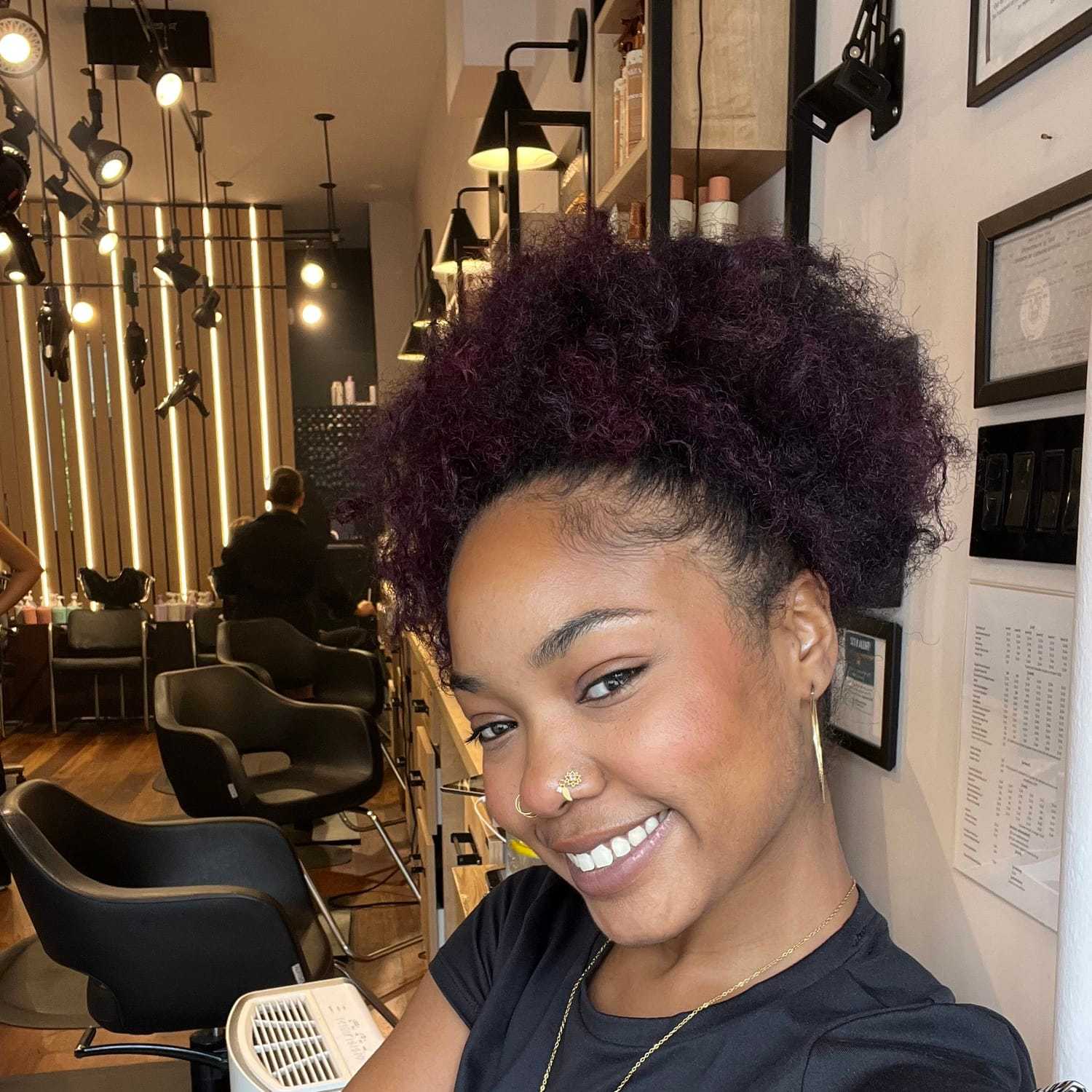 Portrait of Sydne, a professional stylist at [salon] 718, showcasing their expertise and style.