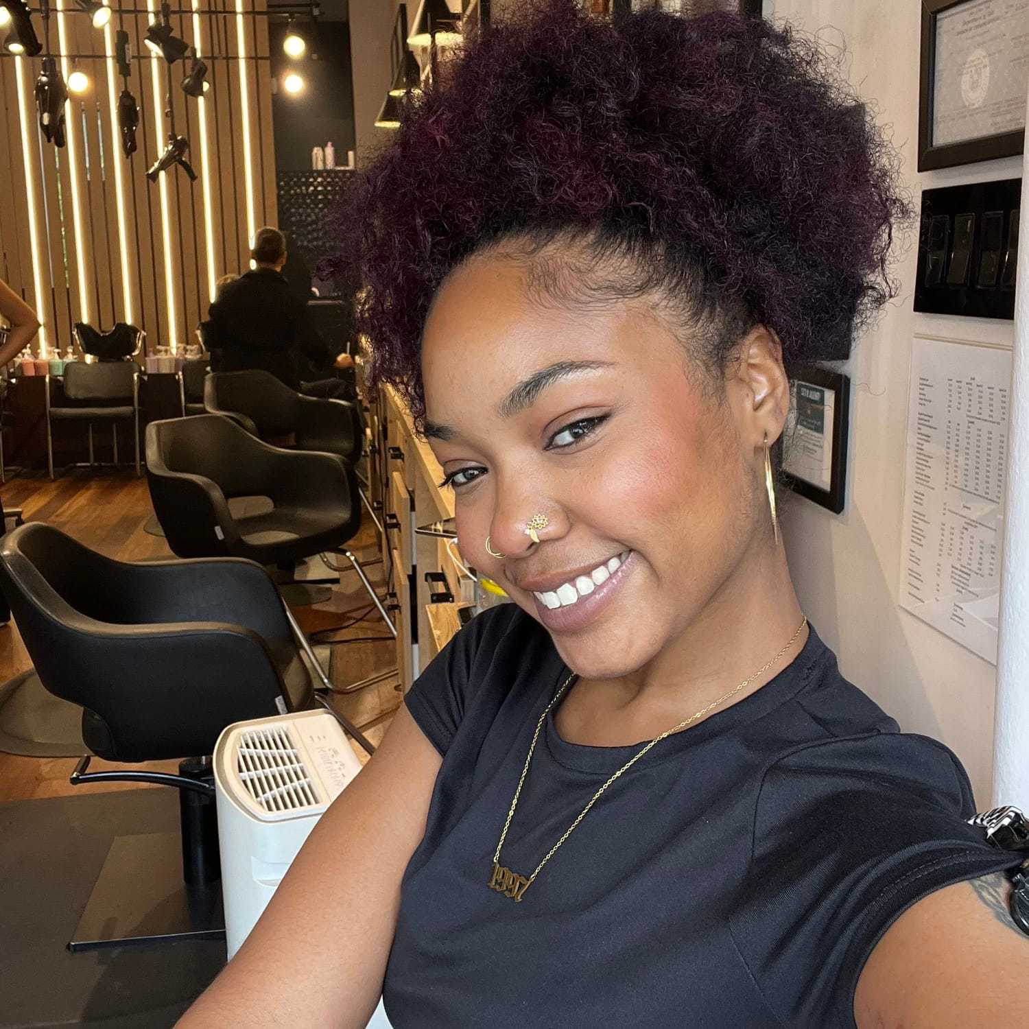 Portrait of Sydne, a professional stylist at [salon] 718, showcasing their expertise and style.