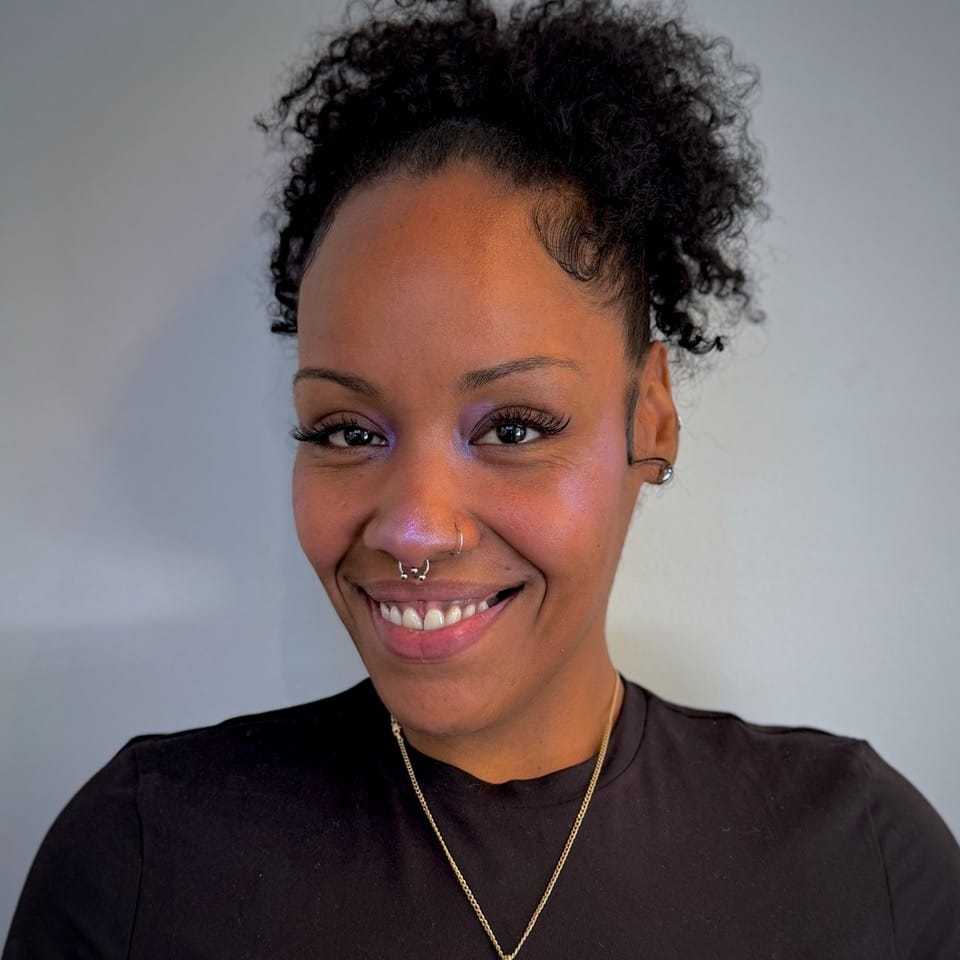 Portrait of Krystal, a professional stylist at [salon] 718, showcasing their expertise and style.
