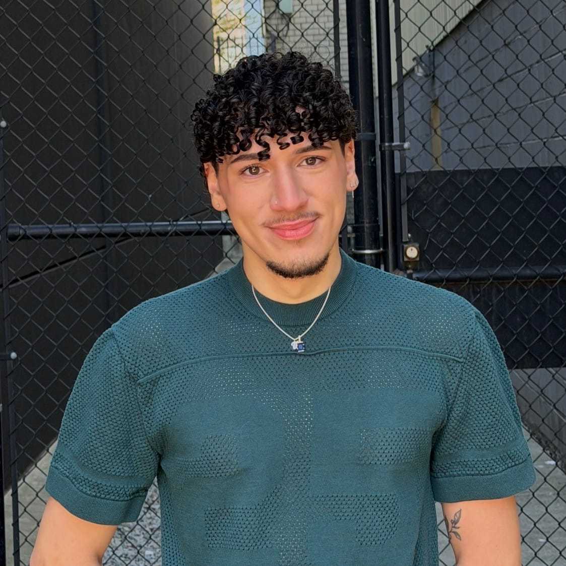 Portrait of Brandon, a professional stylist at [salon] 718, showcasing their expertise and style.