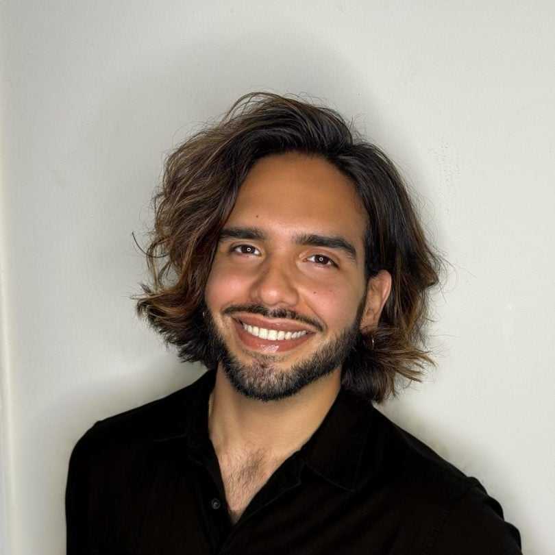 Portrait of Evan, a professional stylist at [salon] 718, showcasing their expertise and style.