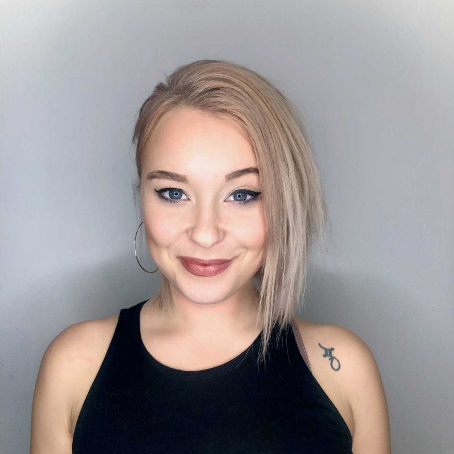 Portrait of Lauren, a professional stylist at [salon] 718, showcasing their expertise and style.