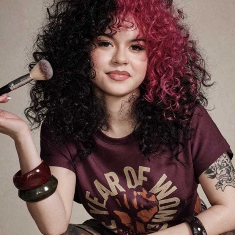 Portrait of Sophie, a professional stylist at [salon] 718, showcasing their expertise and style.