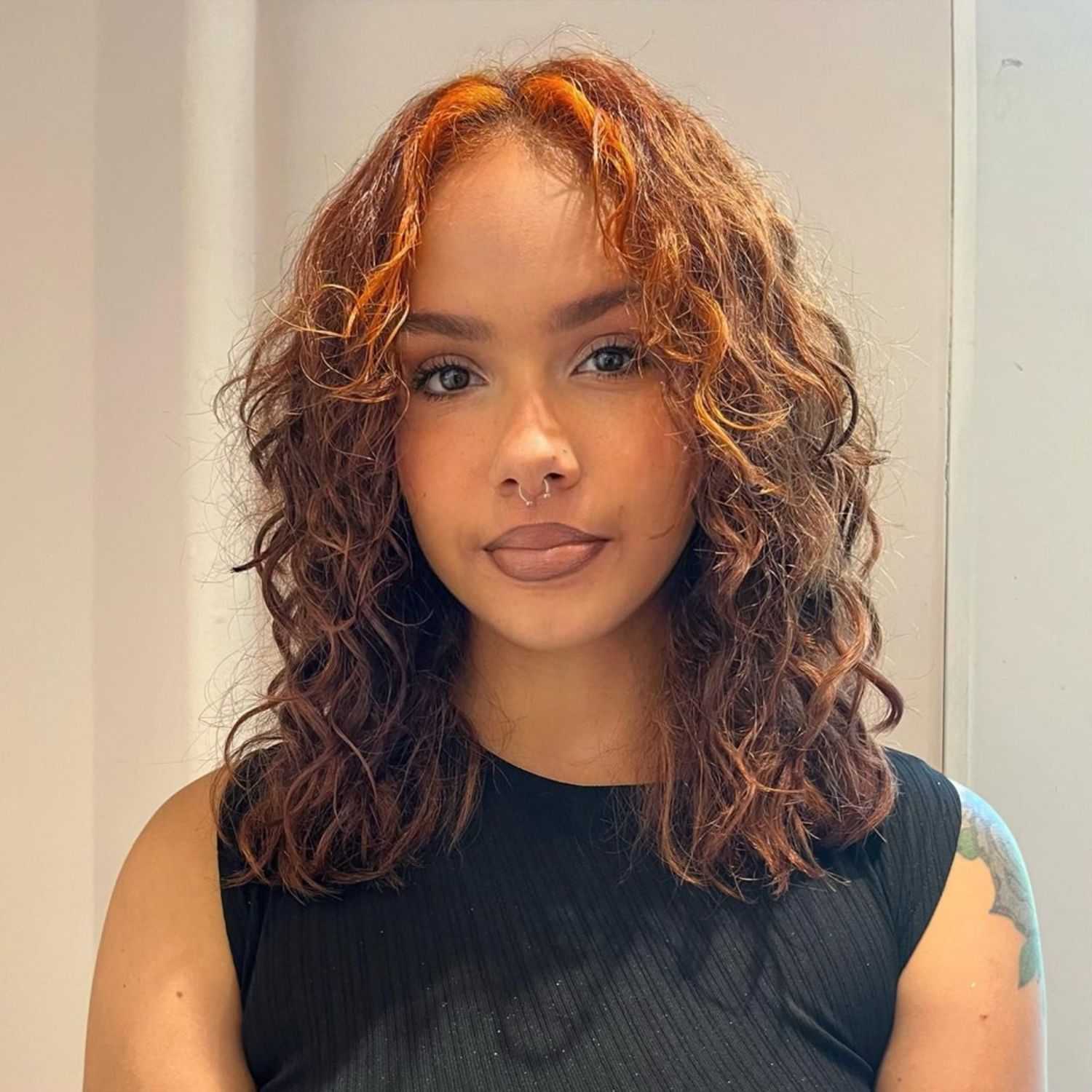 Portrait of Iyanna, a professional stylist at [salon] 718, showcasing their expertise and style.