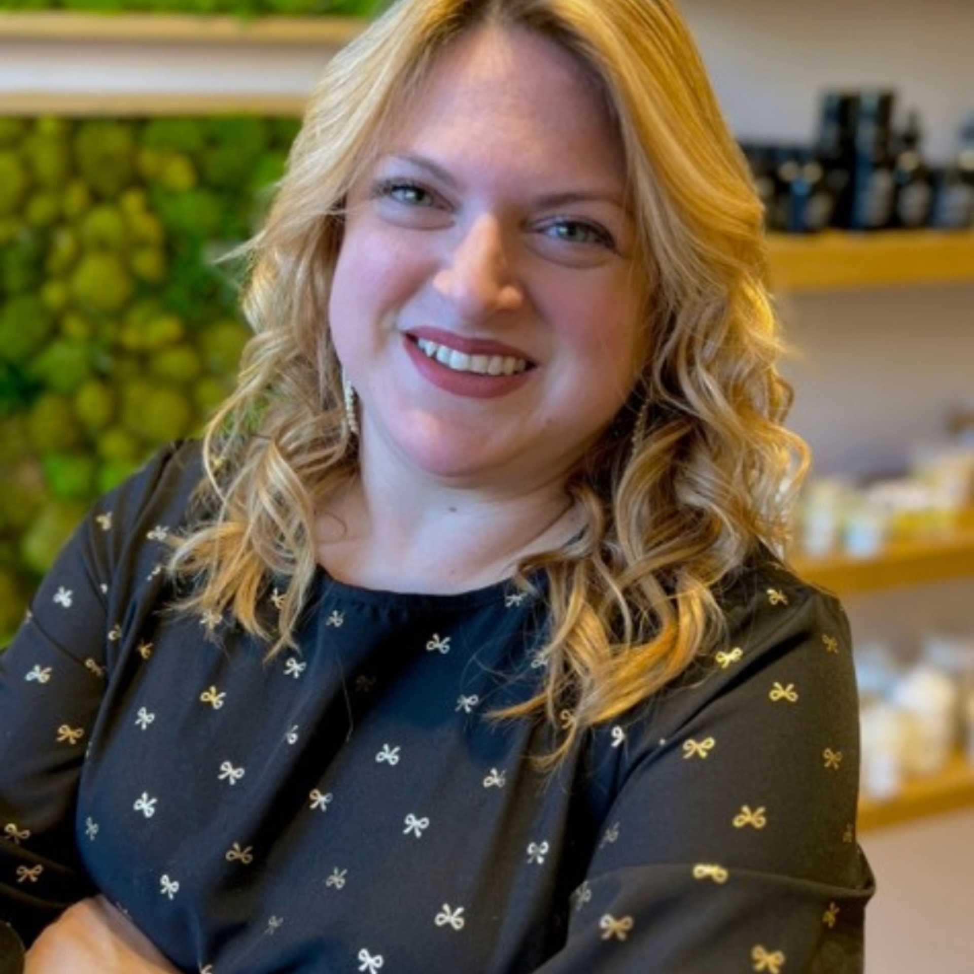 Portrait of Laura, a professional stylist at [salon] 718, showcasing their expertise and style.